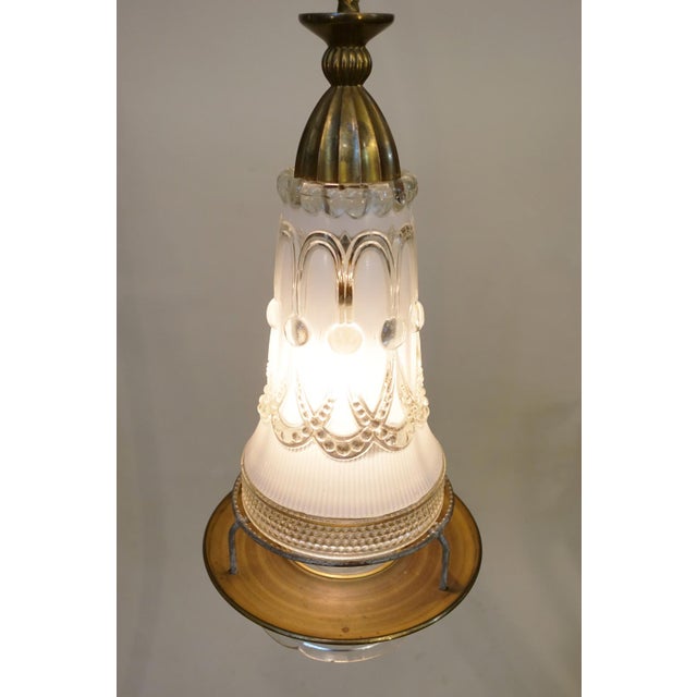 A dramatic and sculptural Hollywood Regency Lightolier stunning finely detailed slag glass pendant lantern shaped form...