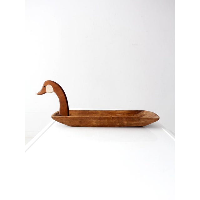 Hand-carved with a sculptural duck head rising from its elongated bowl, this vintage wooden tray combines rustic charm...