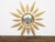 A vintage French gilt metal sunburst mirror from the mid 20th century, with convex plate, foliage leaves and molded frame....