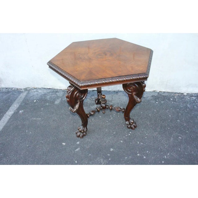 Gorgeous English heavily carved center side end occasional accent table, 19th Century, featuring a hexagonal shaped book...