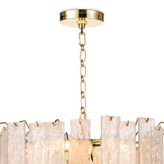 Panes of striking water glass adorn the large Glacier chandelier to create a dynamic piece full of movement. The glass...