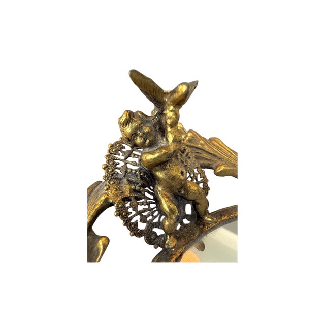 Stunning and rare vintage mirrored tray, with gilt cherubs & vines. It measures approximately 21”w X 14”d, and it is in...