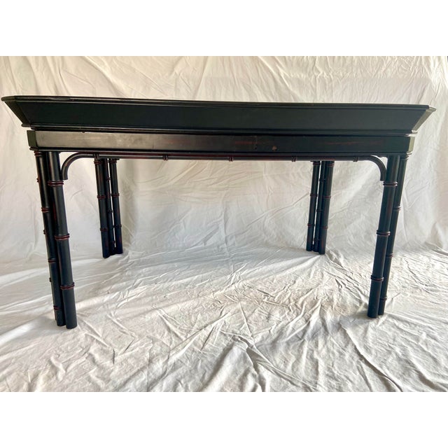 Vintage faux bamboo tray table made by Baker Furniture. Original paint with faint dark maroon accents throughout piece....