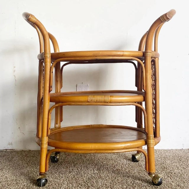 Amazing vintage bohemian three tier bamboo rattan bar cart. Features a natural finish with a lattice panel on the sides.