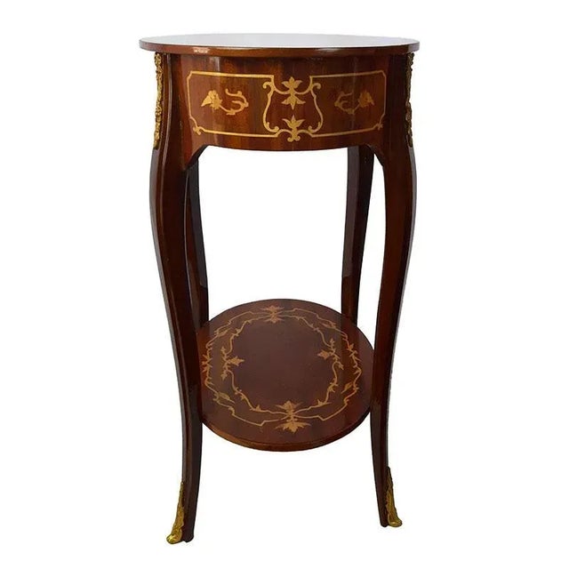 Walnut coffee table decorated in various woods, gilded bronze finishes, a central drawer and a shelf in the lower part....