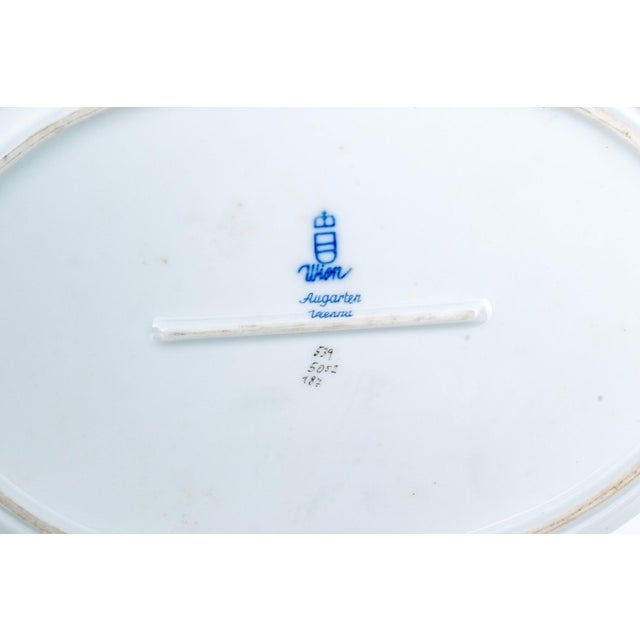An exquisite 5-piece collection of fine porcelain from Europe's second-oldest manufactory, Augarten Wien. Hand-painted in...