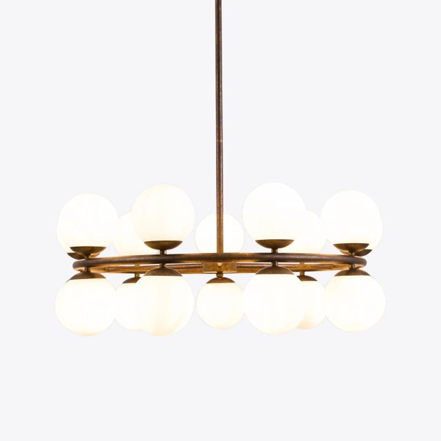 A striking, vintage inspired circular sputnik chandelier in an aged brass finish. This neatly proportioned design features...