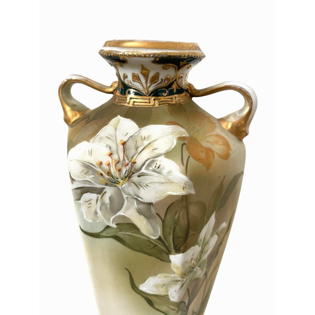 This Antique Hand Painted LFH Nippon Gold Encrusted Lilies Floral Vase is a beautiful piece of porcelain and pottery art...