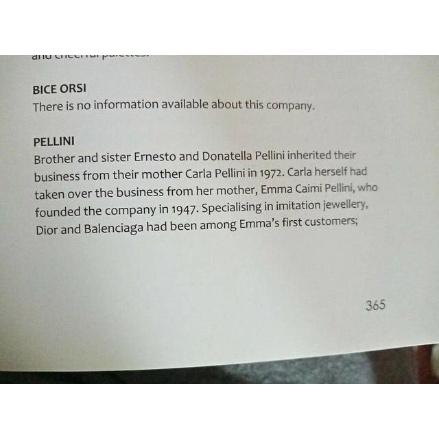 This is part of Chairish’s Costume Jewelry assortment. 1980s round goldtone ridged with cabochon faux-lapis center clip...