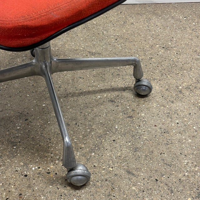 c. 1970s. Uncommon chair upholstered in red/orange fabric. Signed. This piece is attributed to the mentioned...