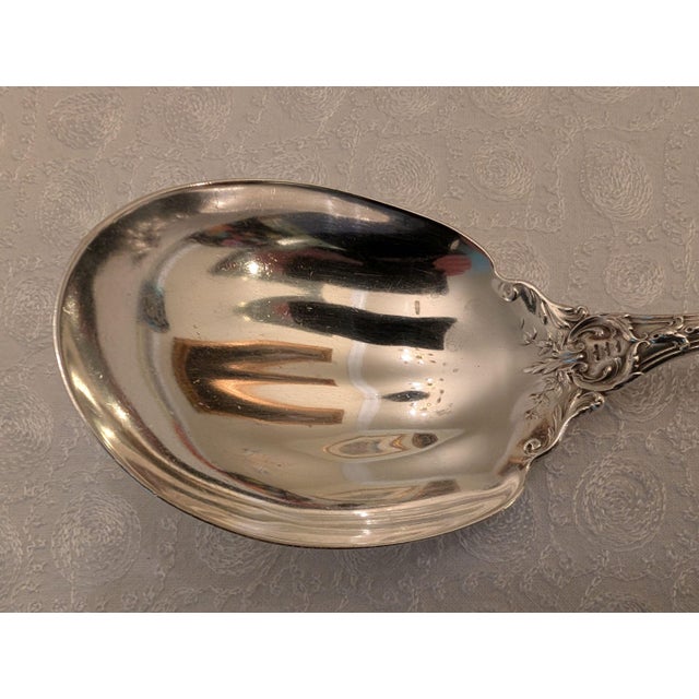A large, sterling silver serving spoon in the legendary pattern "Francis I" by Reed & Barton. Officially identified by the...