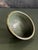 Very nice understated studio pottery bowl featuring a deep glaze exterior and a neutral green glazed interior. Exterior...