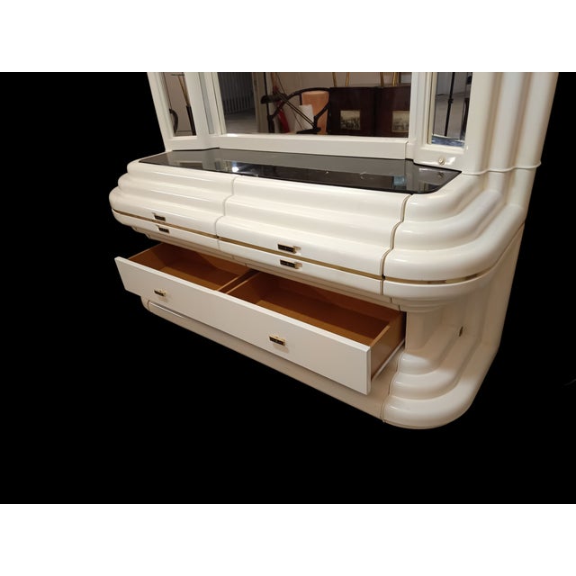 Magnificent Space Age chest of drawers in lacquered wood featuring a large illuminated mirror.