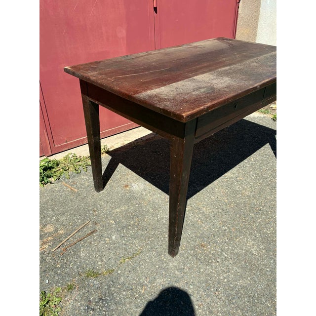 Beautiful dining table in dark oak (very dark brown/black). Features two drawers on one side. Dimensions: 74 x 129 cm....