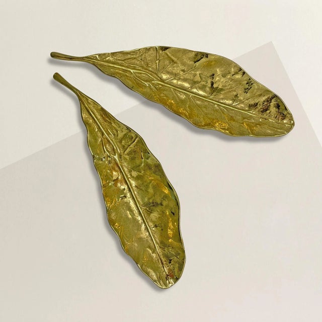 A pair of chic vintage American solid cast brass tobacco leaf dishes, perfect for holding paperclips, pens, chocolates, or...