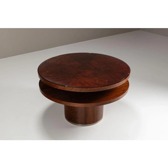 This circular table is veneered in richly figured mahogany, its top displaying an intricate play of grain beneath a...