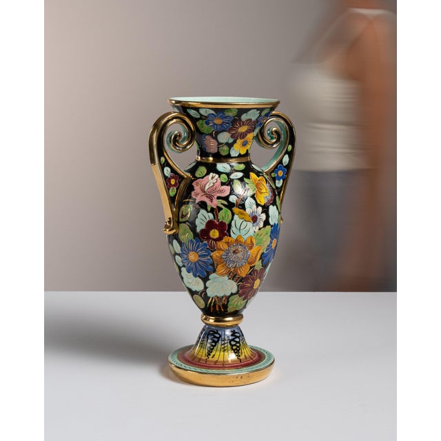 This mid 20th century Mid-Century Modern Vallauris amphora from France is glazed in black and hand-painted with a riot of...