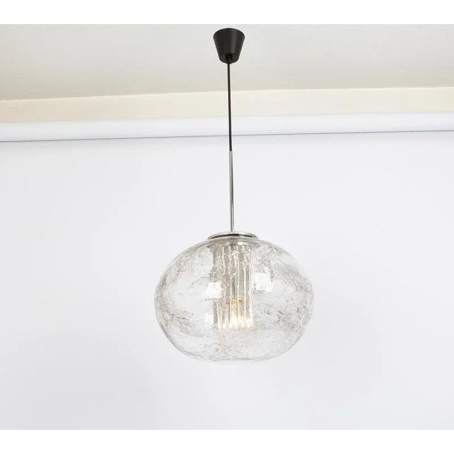 Doria ceiling light with large volcanic glass ball. High quality of materials, gives a wonderful light effect when it is...