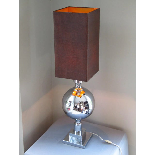 This mid-century chrome table lamp was produced in France in 1968 and features a snakeskin-look lampshade. European Plug...