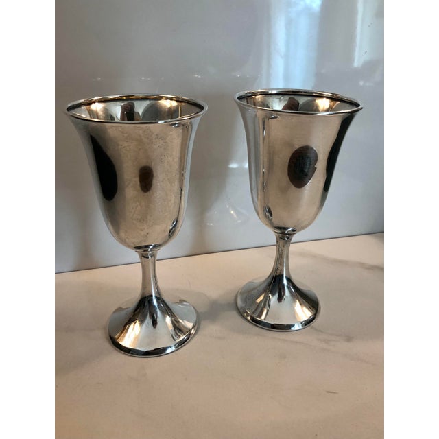 Beautifully proportioned, this vintage pair of sterling silver goblets with gilded interior are marked STERLING with the...