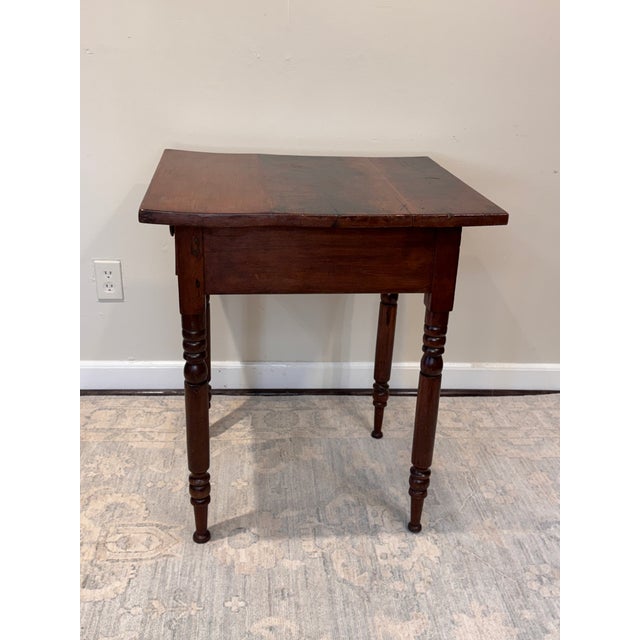 The table is an American Sheraton or Late Federal style single-drawer stand, also commonly called a work table or side...