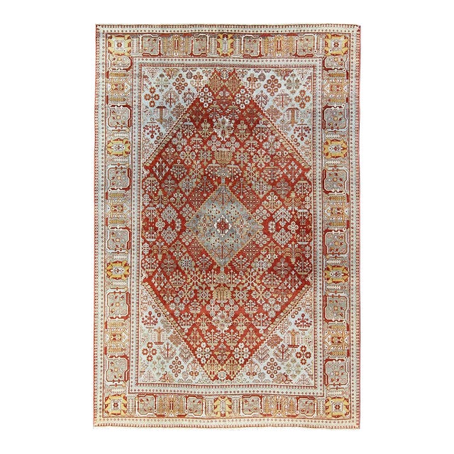 Early 20th Century Antique Persian Joshegan Rug With Geometric Medallion Design in Rust and Ivory For Sale