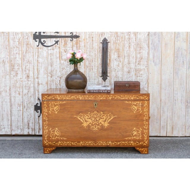 A vintage oversized inlay Dutch colonial trunk with large ornate gilded handles. This large walnut veneered chest features...