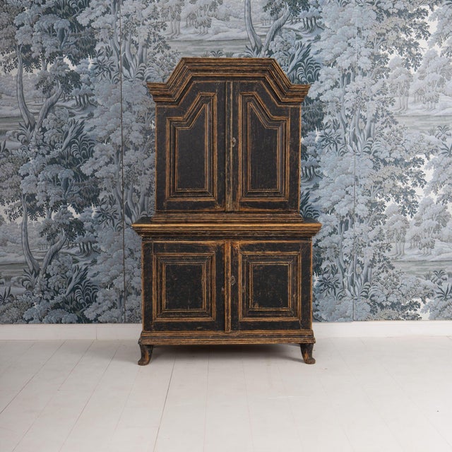 A rare two-part, Swedish cabinet from the Baroque period with charming bear paw feet in original paint. Original hardware...
