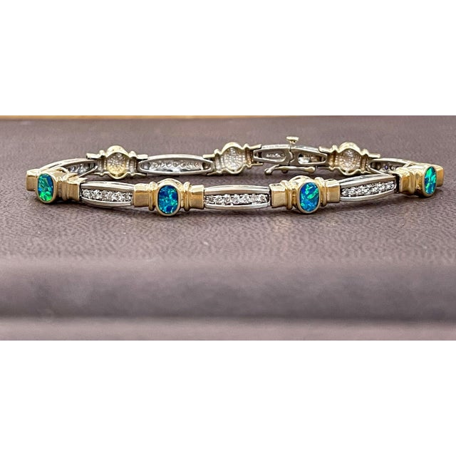 This exceptionally affordable Tennis bracelet has Multiple stones of Opal in Oval shape . It has yellow and White gold...