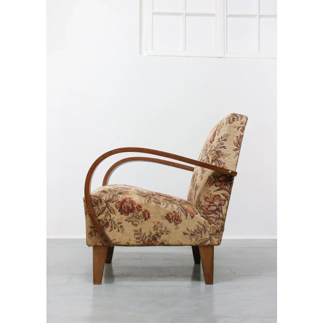 This armchairs shows the classical arch. Original upholstery with floral design. This piece is attributed to the mentioned...