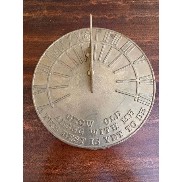 A stunning vintage iron garden sundial reading "Grow old along with me. The best is yet to be." USA, Late 20th Century...