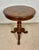 Elegant round occasional table featuring a beautifully inlaid top and sculptural tripod base. The circular top displays...