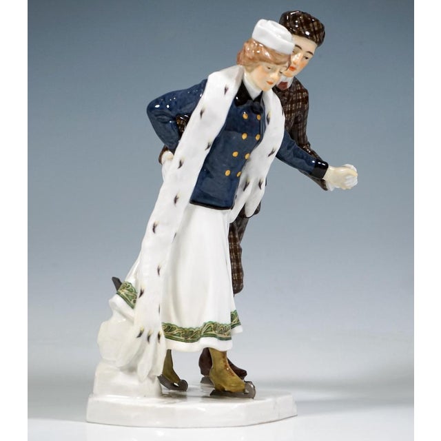 Delicate meissen art nouveau porcelain group: a couple skating in elegant winter attire: the lady in a long white skirt...