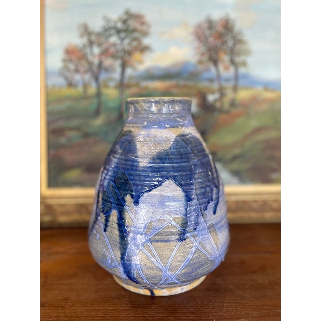 This hand-thrown studio pottery vase features a bold and expressive glaze treatment in layered tones of cobalt,...