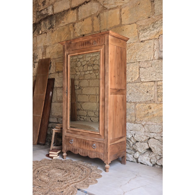 An elegant antique walnut wardrobe, restored and stripped to reveal the wood's particularly striking natural grain. with...