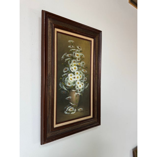 A charming 1970s oil on canvas still life by Janey Lee, featuring a graceful bouquet of white daisies arranged in a simple...