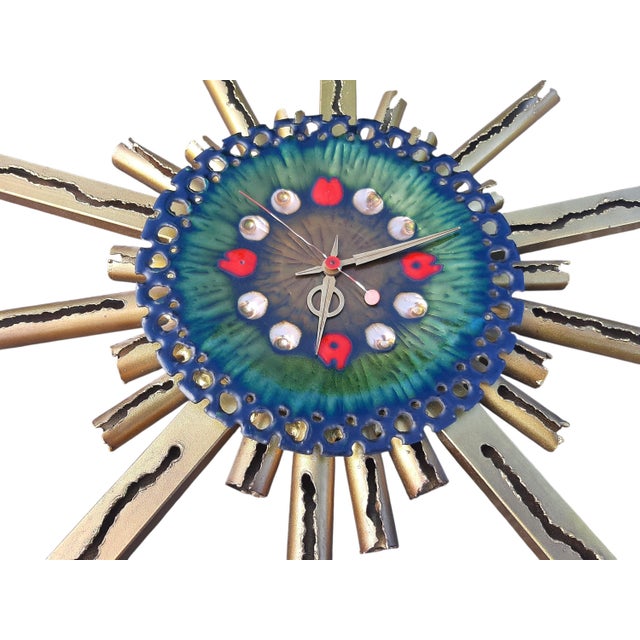 Clock in Enameled Copper and Iron with Sunrays, 1950s, in Very Good conditions. Designed 1950 to 1959 This piece has an...