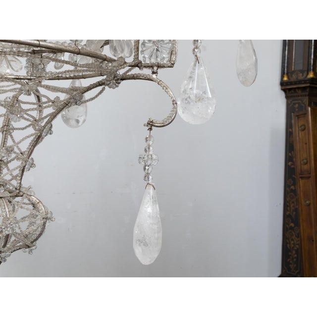 An Italian 1920s rock crystal eight-light chandelier with petite beads draping the silvered metal frame. Elevate your...