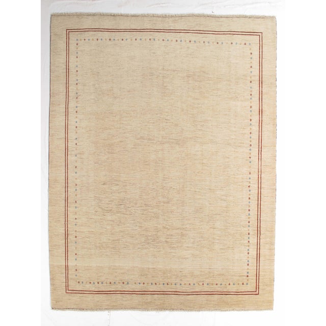 Vintage hand-knotted Persian Fine Lori Gabbeh rug featuring a soft, open field with a delicate linear border and subtle...