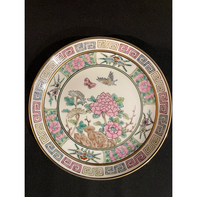 This hand painted Gold Imari set features fluttering butterflies, pink, blue and yellow flowers, geometric frieze and...