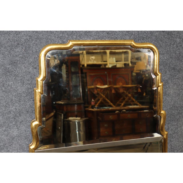 Make a dramatic statement with this exceptional Hollywood Regency gilded wall mirror, a sophisticated mid-century design...