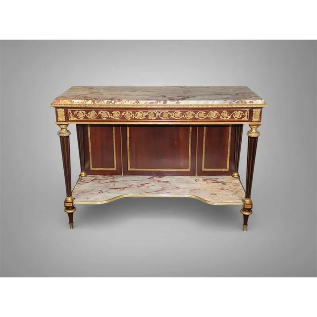 A stunning, museum-quality 19th-century French console table, masterfully executed in the elegant Louis XVI style. This...