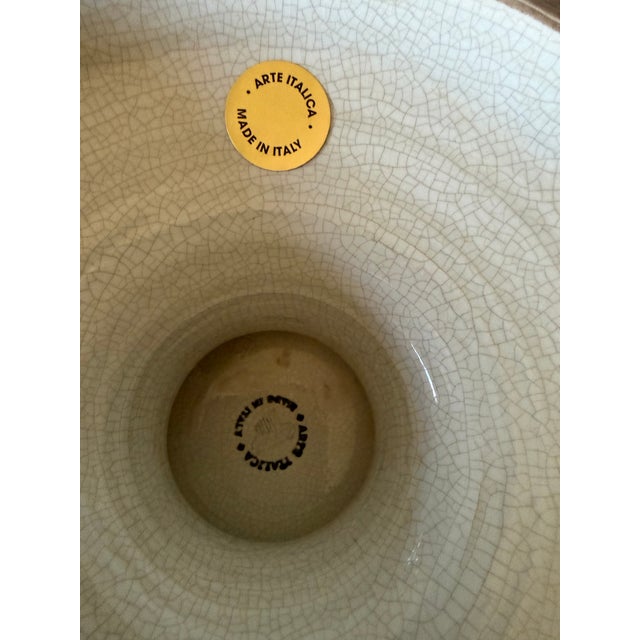 Beautiful cream pedestal bowl from Arte De Italica. Lovely raised emblem and impressive size.