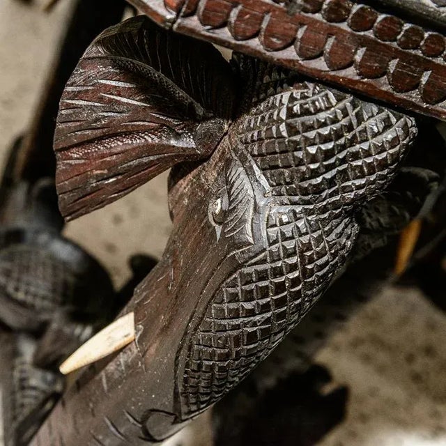 Vintage octagonal elephant table. Extensive carved details and inlay top with raised wood elephant with tusks and inlay of...