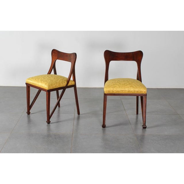Pair of chairs in shaped and curved wood, restored and re-finished, produced by Ducrot, Italy, 1920s. Wear consistent with...