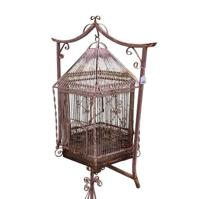 This vintage iron birdcage on stand is a charming and rustic addition to any home decor. The birdcage, made of iron and...