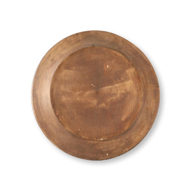 This antique hand-carved wooden bread dish showcases traditional craftsmanship with an intricate floral engraving at the...