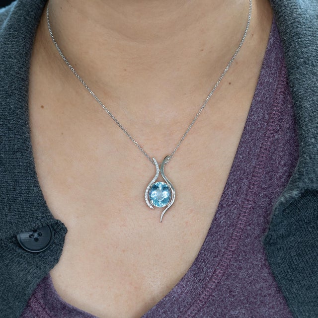 A breathtaking 7.8ct Santa Maria aquamarine glows with deep, oceanic blue, accented by natural diamonds in solid 14K gold....