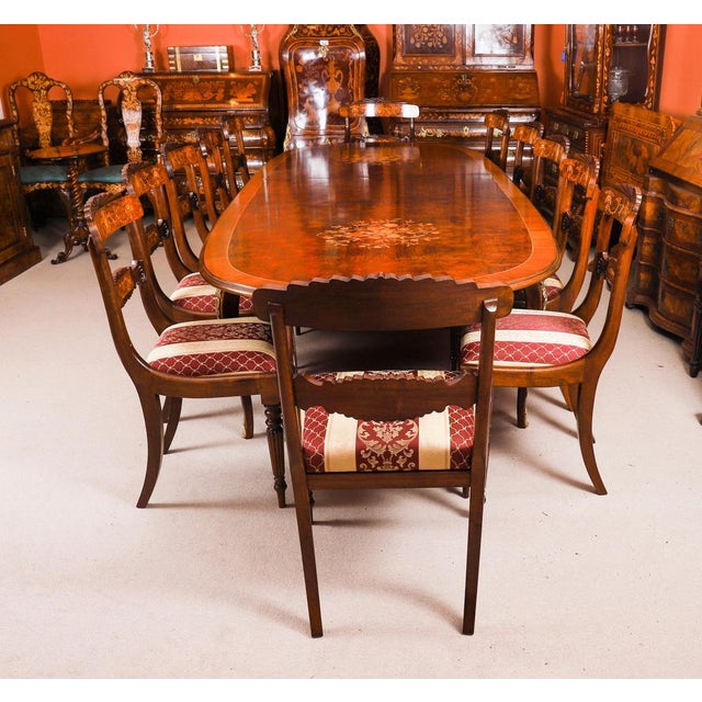 This is a beautiful antique French Louis Revival ormolu mounted dining table, circa 1920 in date and a set of twelve burr...
