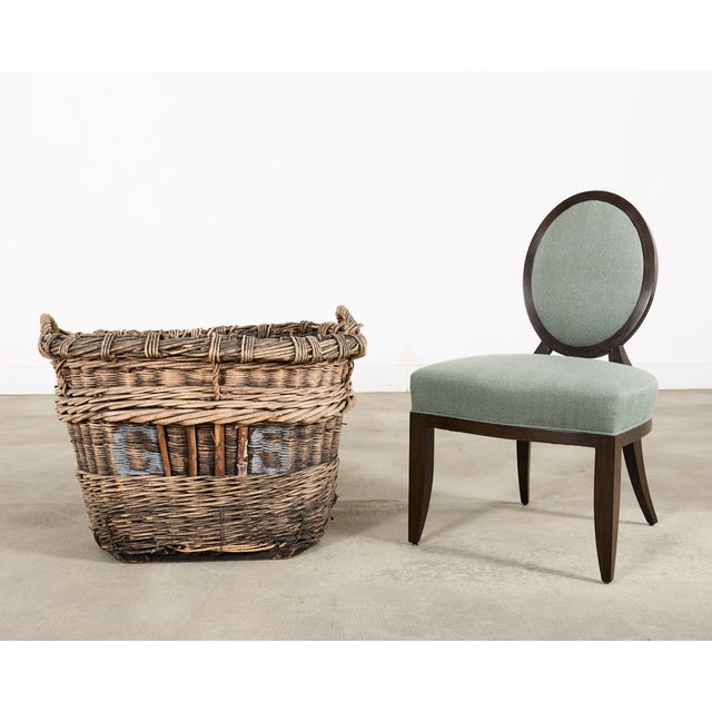 A large and beautifully weathered handwoven French vineyard wine harvest basket in thick woven wood wicker, rattan reed,...